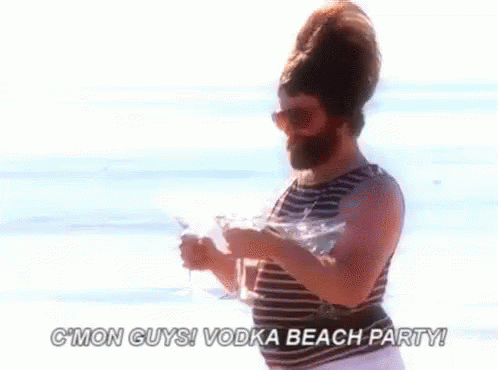 Bearded Man On Beach Holding Vodka And Martini GIF