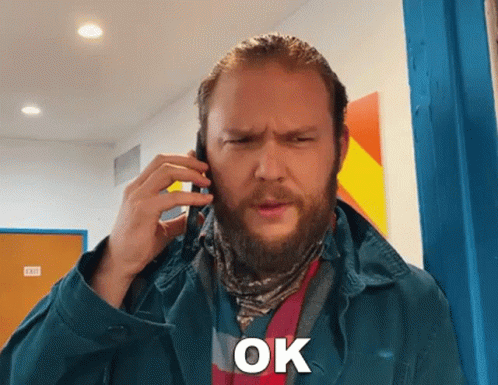 Bearded Man on Cell Phone Saying Ok