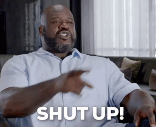 Bearded Man On Couch Pointing Saying Shut Up