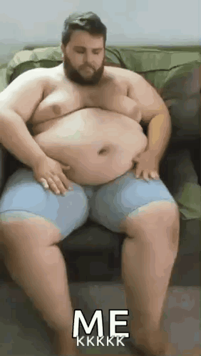 Bearded Man on Couch With Hands on Belly