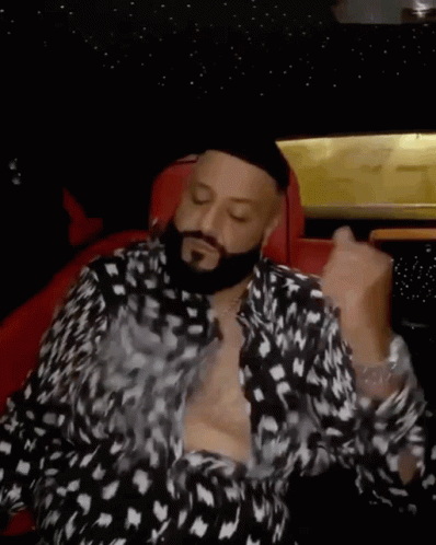 Bearded Man Shirtless in Car
