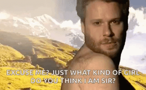Bearded Man Shirtless in Front of Mountains