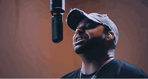 Bearded Man Singing Into Microphone in Studio