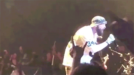 Bearded Man Singing Into Microphone