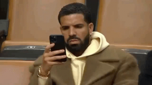 Bearded Man Sitting And Looking At Phone GIF