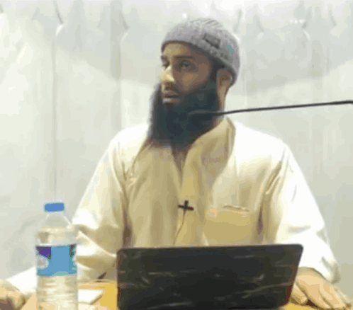 Bearded Man Sitting at Laptop With Aquafina Water
