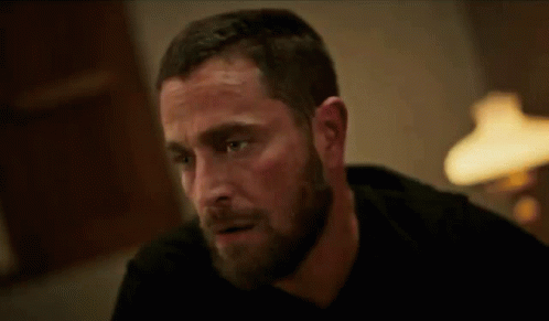 Bearded Man Sitting At Table With Lamp GIF