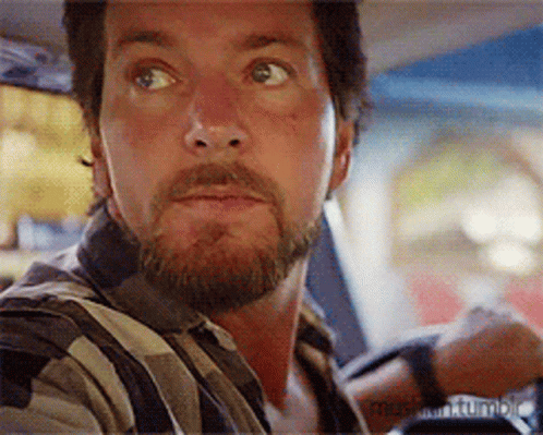 Bearded Man Sitting in Car Looking at Something