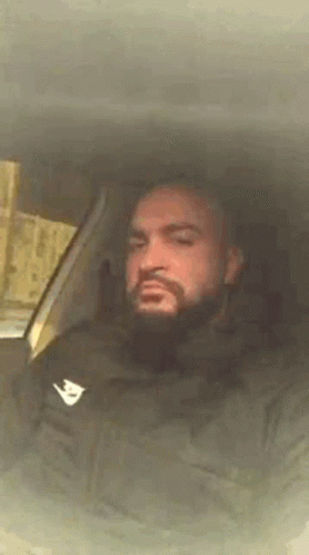 Bearded Man Sitting in Car With Eyes Closed