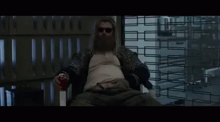 Bearded Man Sitting in Chair Holding Soda Can