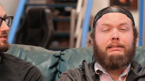 Bearded Man Sitting on Couch Eyes Closed