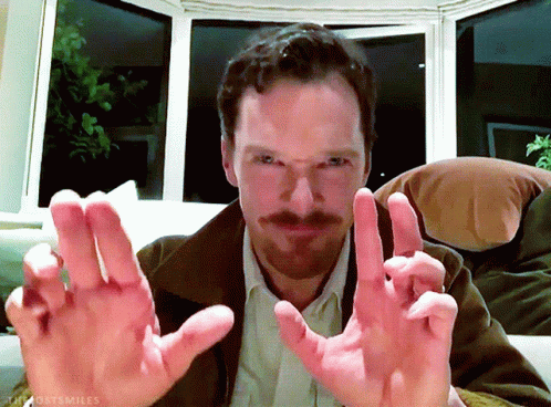 Bearded Man Sitting on Couch Hands Outstretched