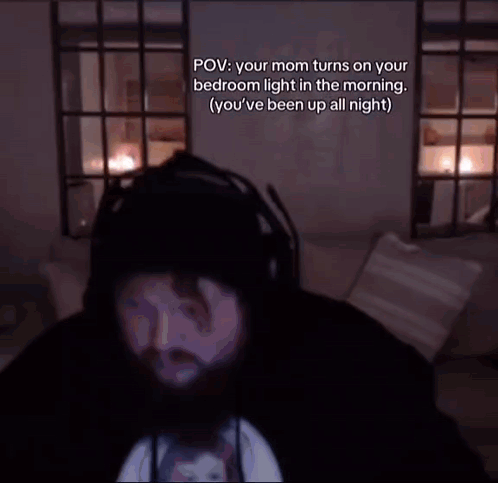 Bearded Man Sitting On Couch In Dark Room GIF