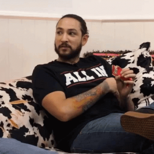 Bearded Man Sitting on Couch in T-Shirt