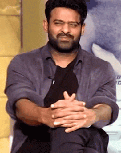 Bearded Man Sitting With Folded Hands
