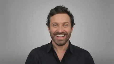 Bearded Man Smiling and Pointing at Camera