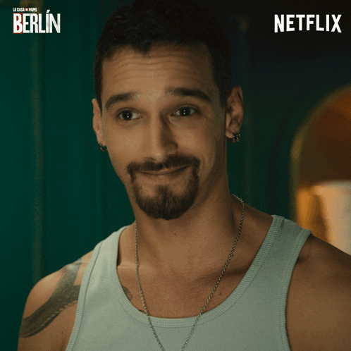 Bearded Man Smiling in Front of Berlin Poster