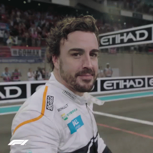 Bearded Man Smiling In Front Of Etihad Sign GIF