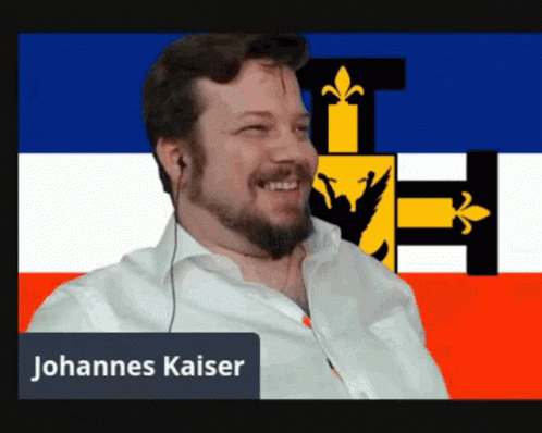 Bearded Man Smiling In Front Of Flag Johannes Kaiser GIF