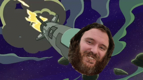 Bearded Man Smiling in Front of Rocket in Space