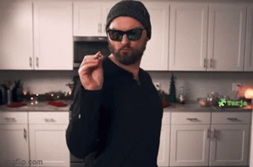 Bearded Man Smoking Cigarette in Kitchen