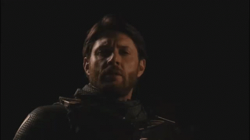 Bearded Man Standing In Darkness With Eyes Closed GIF