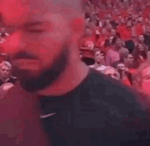 Bearded Man Standing In Front Of Crowd GIF