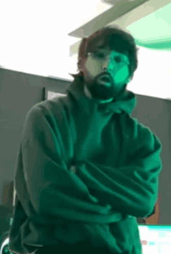Bearded Man Standing with Crossed Arms