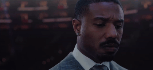 Bearded Man Suit Tie Looking at Camera