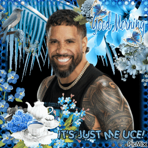 Bearded Man Surrounded by Blue Flowers Saying Good Morning