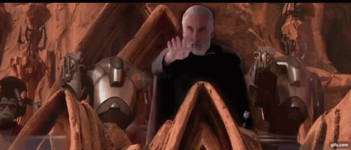 Bearded Man Surrounded by Robots