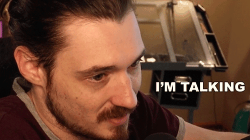 Bearded Man Talking in Front of Desk