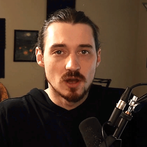 Bearded Man Talking Into Microphone
