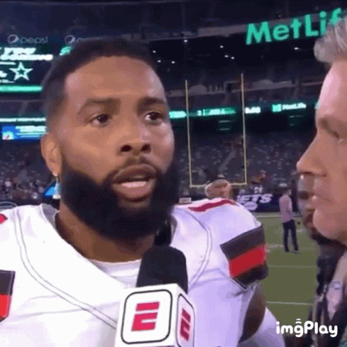 Bearded Man Talking Into Microphone With MetLife Sign