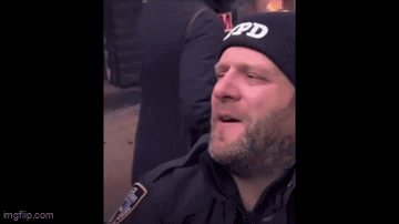 Bearded Man Touched by Police Officer in Black Hat