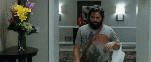 Bearded Man Walking Down Hallway GIF