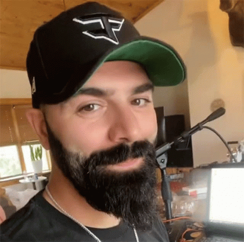 Bearded Man Wearing Black Hat With Letter E