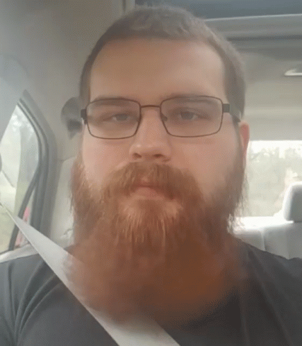 Bearded Man Wearing Glasses Sitting in Car