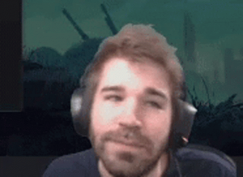 Bearded Man Wearing Headphones Against Green Background