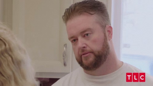 Bearded Man Wearing White TLC Shirt