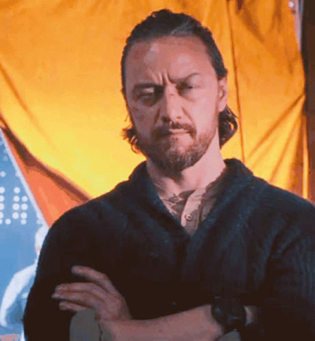 Bearded Man With Arms Crossed In Front Of Yellow Curtain GIF
