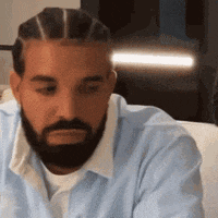 Bearded Man with Braids Sitting on Couch