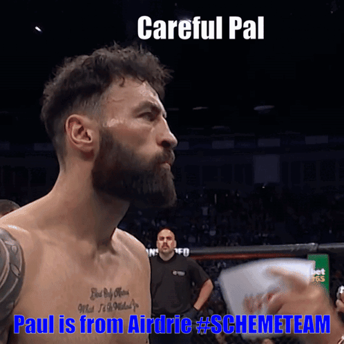 Bearded Man With Chest Tattoo in Boxing Ring Saying Careful Pal