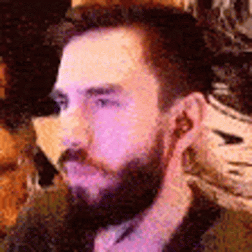 Bearded Man With Earbuds Sitting at Table