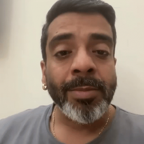 Bearded Man With Earrings in Gray Shirt