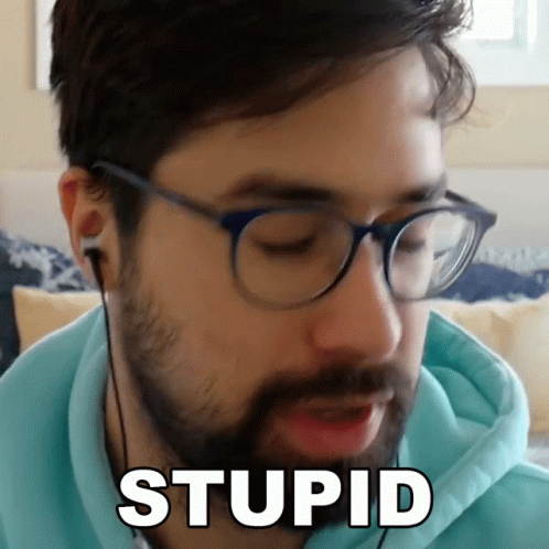 Bearded Man With Glasses and Ear Buds Saying Stupid