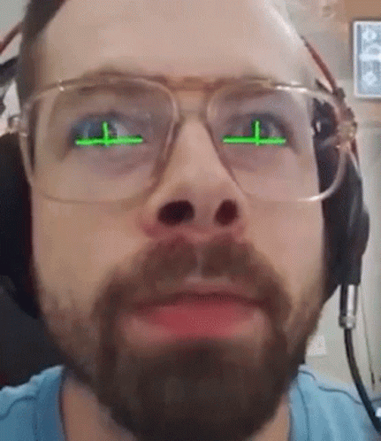 Bearded Man With Glasses and Headphones and Green Eyes
