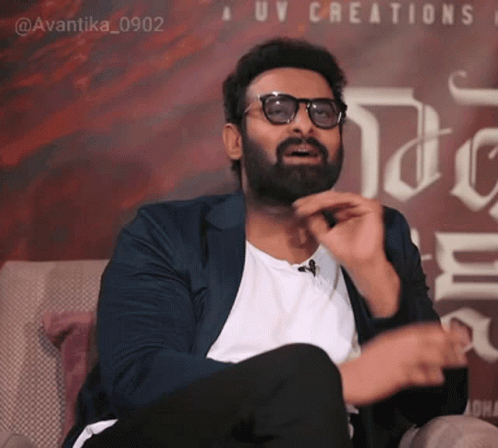 Bearded Man With Glasses and UV Creations Sign