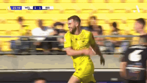 Bearded Man With Glasses Smiling In Crowd GIF