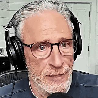 Bearded Man With Glasses Wearing Headphones Talking Into Microphone GIF